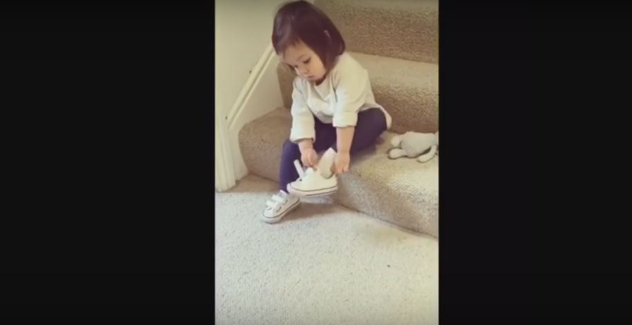 Independent Little Girl Puts On Shoes And Coat All By…